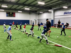 Young athletes in a hit club practice session, showcasing dedication and baseball training.